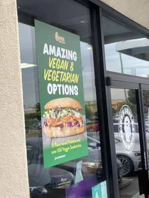 Outdoor signage promoting vegetarian and vegan sandwich options   at Ike's in Carson