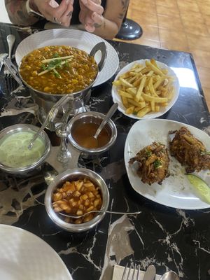 Our mains with chips and onion bhajis as a side   at Curry 'n' Grill House in Tenerife