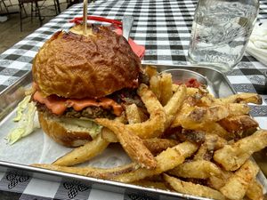 Burger on pretzel bun w/salt & vinegar fries  at Eris Food Co in Oceanside
