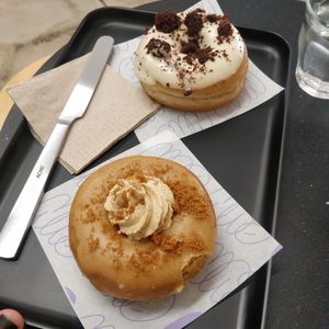 White chocolate donut in back and lotus biscoff donut in front at Bun and Coffee in Malaga