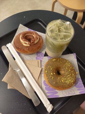 Pistachio and tiramisu doughnuts and iced matcha latte at Bun and Coffee in Malaga