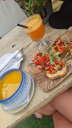 Carrot/cilantro soup, tomato&garlic bruscetta and fresh carrot, ginger, apple juice at U Bistrot in St Julians