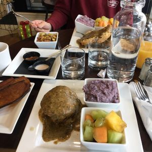 Brunch: eggplant bacon, tempeh sausage, biscuits and gravy, blue grits, roasted potatoes, fruit at Good Life Cafe in Columbia