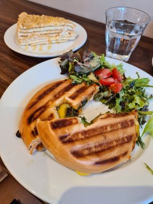Pesto Bagel and Russian Honey Cake in the background at Nama Café and Cake House in South East London