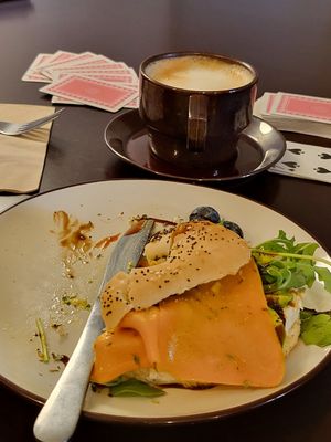 Bagel, coffee and cards! at Comércio Café Coworking in Porto