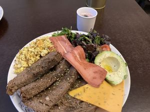 Vegan Salty brunch - included toast, tofu scramble, “bacon”, “cheese”, salad, avocado, juice, coffee   at Comércio Café Coworking in Porto