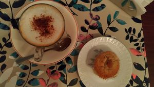 vegan almond muffin and cappuccino with soy milk at Comércio Café Coworking in Porto