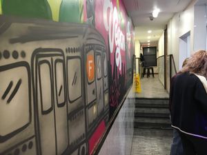 Long hallway where you order, pick up good, and stools to it in the back. at Vegan On The Fly in New York City