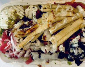 Chick’n on top of a salad that had lettuce, tomatoes, olives, dolmas and white sauce I added pickles and 1/2 a pita which they cut into strips and laid on top. Great idea!!!  at Vegan On The Fly in New York City
