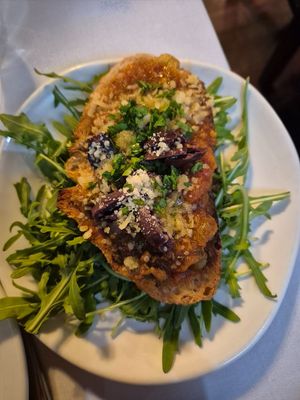 Bruschetta piccante $11 for one piece!! Bread was soft (would be much better crunchy) tomato paste w/olive slices, parmesan, and rocket, not what was expected at all at Funghi E Tartufo in Melbourne
