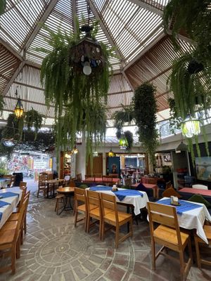 Seating is under this leafy dome area, a cool space  at Las Chinitas in Panajachel
