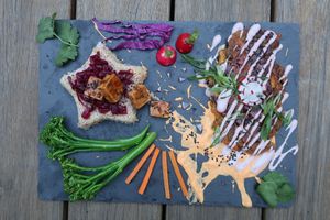 Pan- Asian Platter with okonomiyaki, glazed tofu, fermented cabbage, brown rice and rainbow vegetables at Wild Love Vegan Food in Los Angeles