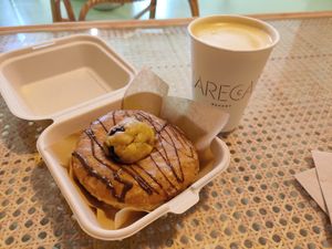 Cookie dough doughnut and big coffee with sou milk at Areca Bakery in Barcelona