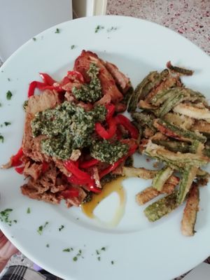 Seitan with peppers served with tipical Piedmontese sauce "Bagnet vert"  at Osteria di Filia in Castellamonte