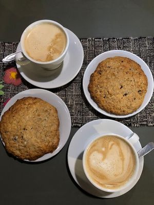 Italian styled coffee with almond and peanut milk. A delicious soft and big chocolate, banana and  oat cookie.   at Logros Café in Jujuy