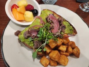 Avacado toast with impossible lardons and cashew cream cheese with a side of potatoes and fruit at Eden in Hot Springs