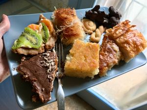 A small snack......Orange pie, fruit tart slice, chocolate brownie tiramisu, cookies, Βραχάκια, Σάμαλι....and other things I cannot translate! at Little Bear in Pireas