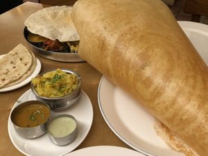 Paper dosa + vegan thali in background at Sagar Vegan & Vegetarian Restaurant - Covent Garden in London