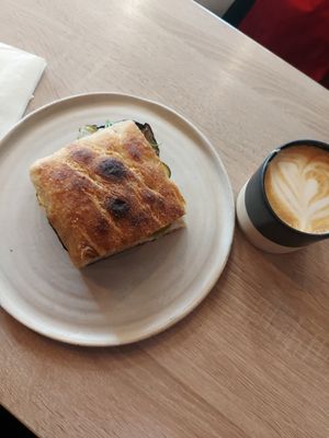 Oat latte and aubergine sandwich at Grain Trip in Bucharest