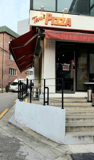 Exterior of location - entrance at Tom's Pizza in Seoul