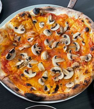 Vegan pizza with vegan cheddar cheese and mushrooms  at Tom's Pizza in Seoul
