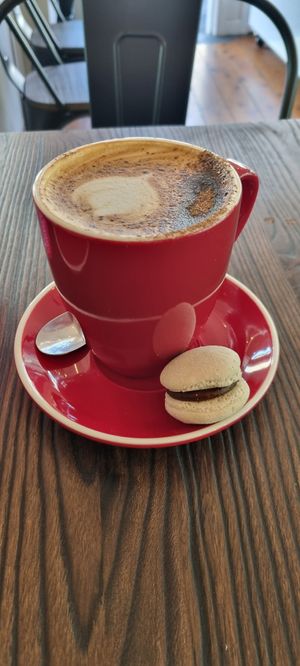 Large soy cappuccino and chocolate macaron at Le Gourmand in Newtown