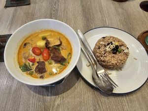 Red curry with vegan duck, cherry and grapes at Khun Churn in White in Bangkok