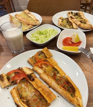 Potato and cheese pita, mushroom and cheese pita, (complimentary tomatoes and chopped lettuce) minced-meat cheese pita with ayran. at Vegan Masa in Istanbul