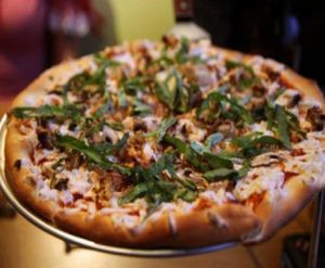 Stretchy teese pizza with gardein chicken, basil, mushrooms and garlic. at Purgatory Pizza in Los Angeles