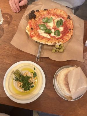 vegan: classic hummus with pita bread. next to the pizza magherita with parmesan on it (😠)  at Esh Pitabar in Amsterdam
