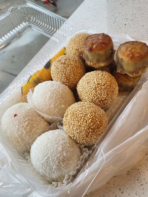 Glutinous rice balls (one peanut and two red bean), red bean sesame seed balls, and lotus mooncakes at Chiu Quon Bakery & Dim Sum in Chicago