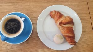 Small Americano, croissant and a pistachio macaroon at Cloud Cakes -  Notre Dame de Lorette in Paris