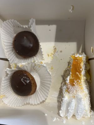 The cake was already half eaten here 😬😅 Mango passion fruit cake and vanilla choux  at Cloud Cakes -  Notre Dame de Lorette in Paris