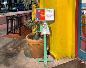 signs outside including covid guidelines   at Jimmy Carter's in San Diego
