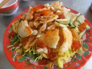 Crispy fried noodles with peanuts, sweet chilli and tomatoe sauce, lettuce and mint. at Tam Thien in Hue