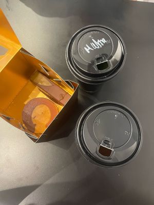 Two hot drinks, a brownie and pistache praline at Enso in Limassol