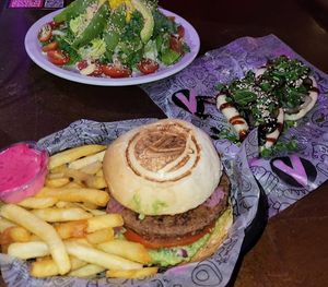 Full vegan burger, mushroom buns, salad at Lado V in Buenos Aires