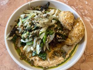Rainbow Harvest Bowl - roasted cauliflower hummus, purple kale, black garlic verde, emerald oil, broccolini, shaved fennel, toasted sunflower seeds and crumbed mushroom  at nodo. in Hawthorne