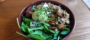 Bowl with whole grains, spinach, hummus, dates, sour cream and Seitan. at De Bon'heur in Marseille