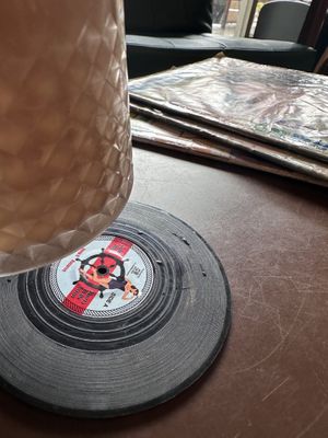 The coaster is a tiny vinyl!!!  at SUSU Vegan Mylk Bar Penang in Penang