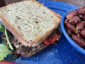 Roman Holiday; hummus, mushrooms, olive tapenade and peppers w maple glaze on amazing bread with awesome baked beans    at Old Cuss Cafe in South Salt Lake