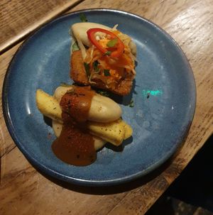 (Top) BHAN MI TOFU crispy fried tofu, cucumber, carrot, cabbage, chilli, coriander, sweet chilli sauce & toasted sesame mayo (Bottom) CHIPPY TEA canoe cut chips, katsu sauce & toga at Wolf at the Door in Manchester