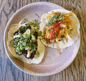 (Left) crispy vegan duck taco: five spiced vegan duck, char sui sauce, toasted sesame mayo, spring onion & cucumber at Wolf at the Door in Manchester