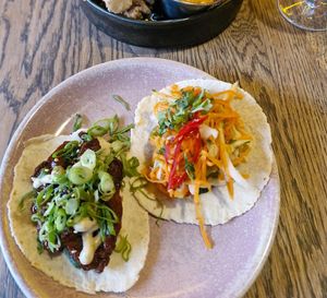 (Right) bhan mi tofu taco: crispy fried tofu, cucumber, carrot, cabbage, chilli, coriander, sweet chilli sauce & toasted sesame mayo at Wolf at the Door in Manchester