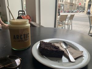 Iced latte with oat milk & sweet potato brownie   at Arctic Juice and Cafe in Lyon