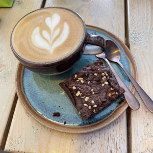Oatly latte & hazelnut brownie  at The Coffee Hut in Helston