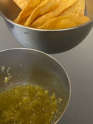 Sides - green sauce and nachos at Ameaça Vegetal in Lisbon