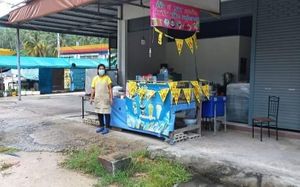 Look out for string of yellow flags with red writing (jae). at Tukta in Koh Tao
