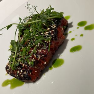 Watermelon marinated in soy sauce, sesame, black quinoa (underneath) at Opasly Tom in Warsaw