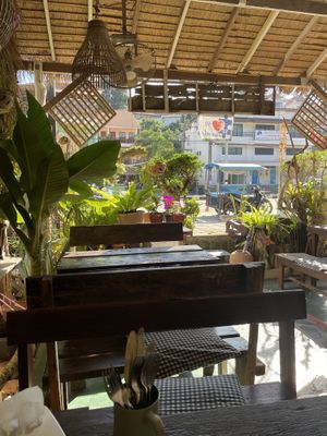 Cosy outdoor seating area with fans at Peak Cafe in Koh Lanta